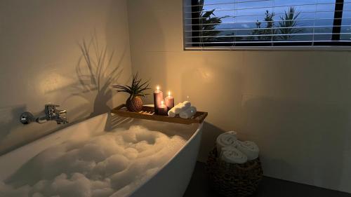 a bathroom with a bath tub with clouds in it at King Suite in Hilton