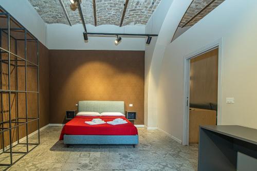 a bedroom with a red bed in a room at suebi rooms and appartament in Termoli