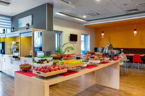 a buffet of fruits and vegetables on a counter in a kitchen at Ibis Izmir Alsancak in Izmir