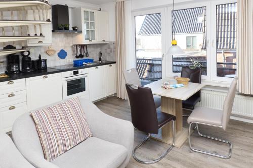 cocina con mesa y sillas y comedor en Haus Mühlentrift Döse, en Cuxhaven