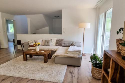 a living room with a couch and a table at New Chalet with breathtaking views! in Alt Sankt Johann