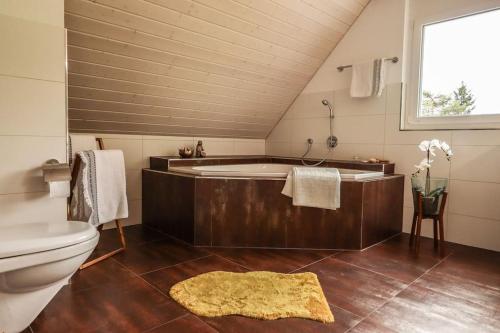 a bathroom with a tub and a toilet at New Chalet with breathtaking views! in Alt Sankt Johann