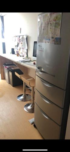 a refrigerator in an office next to a computer desk at 仔鹿 kojika in Nara
