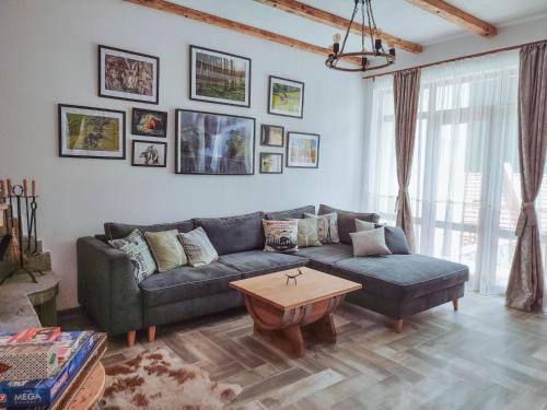 a living room with a couch and a table at Villa Tangra in Grashtitsa