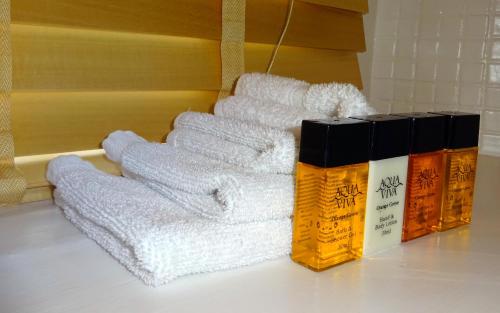 a pile of white towels sitting on a counter next to a shelf at Cherry Cottage, Youlgrave Nr Bakewell in Youlgreave