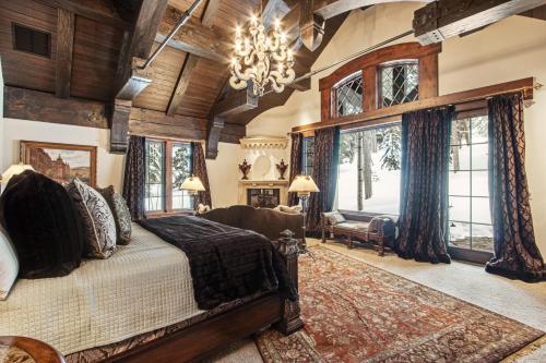 a bedroom with a large bed and a chandelier at Daybreak Ridge in Avon