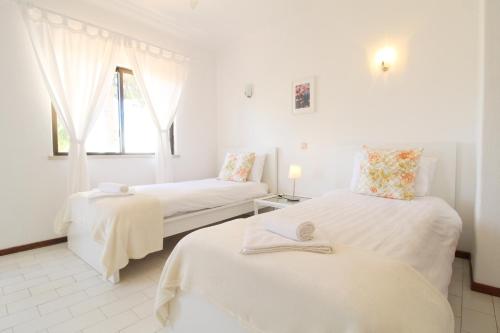 a white room with two beds and a couch at T2 Holiday Cottage near the beach C225 in Porches