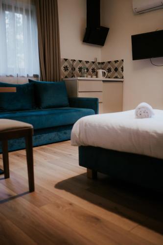 a living room with a bed and a couch at Villa Garden in Oleśnica