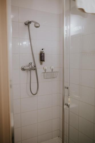 a bathroom with a shower with a glass door at Villa Garden in Oleśnica