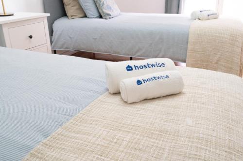 two beds in a bedroom with two pillows on them at Host Wise - Spacious Fresh Flat w Terrace - Near Sea in Espinho