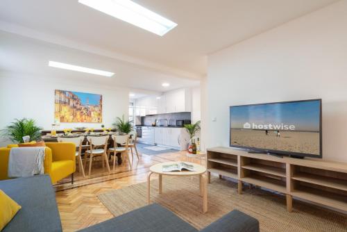 a living room with a large flat screen tv at Host Wise - Spacious Fresh Flat w Terrace - Near Sea in Espinho