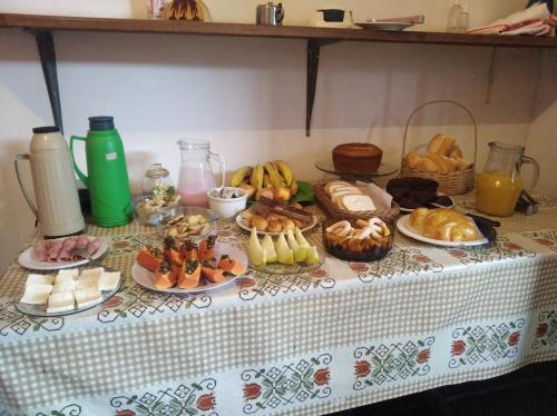 a table with many different types of food on it at Pouso da Luiza in Tiradentes