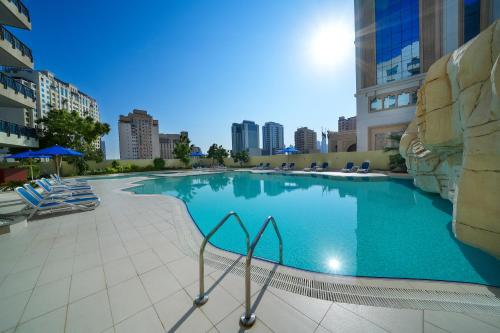 a large swimming pool in the middle of a building at Park Apartments Dubai, an Edge By Rotana Hotel in Dubai