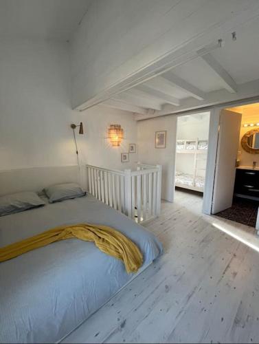 une chambre avec un lit avec une couverture jaune dessus dans l'établissement Appartement lumineux Capbreton, à Capbreton