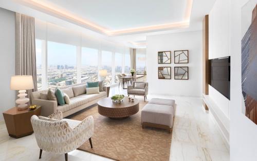 a living room with a couch and a tv at Sofitel Dubai The Obelisk in Dubai