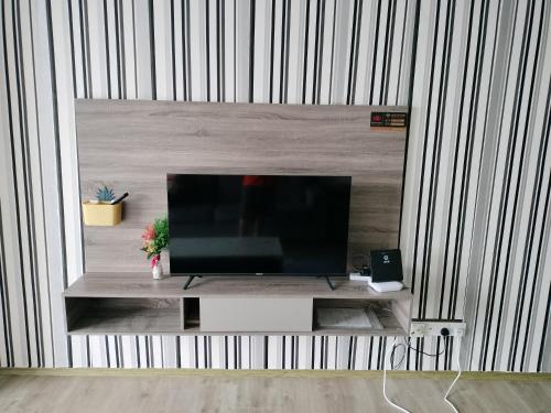 a flat screen tv sitting on top of a entertainment center at 彬彬流星瞭望台 The VenusBlock B 31st floor Sri Manjung in Seri Manjung