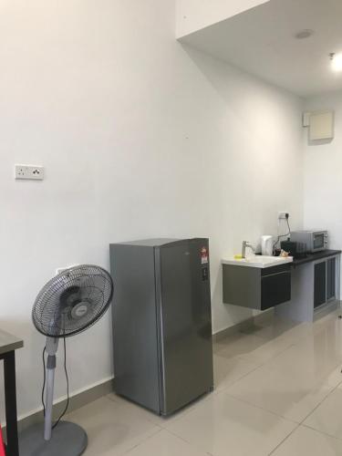 a kitchen with a stainless steel refrigerator and a sink at David Studio Unicity, Seremban 3 in Seremban