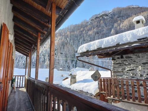 a porch of a house with snow on it at La casa nell'airetta in Balme