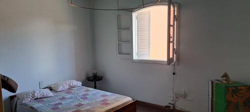 a bedroom with a bed and a window at Hostel LQueen 1 in Salta