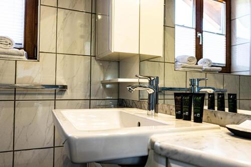 a bathroom with a white sink and a mirror at Himmelseck in Oberstaufen