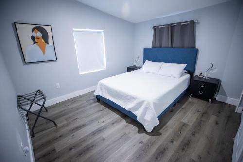 a bedroom with a bed and a chair in it at The Contemporary in Sanford