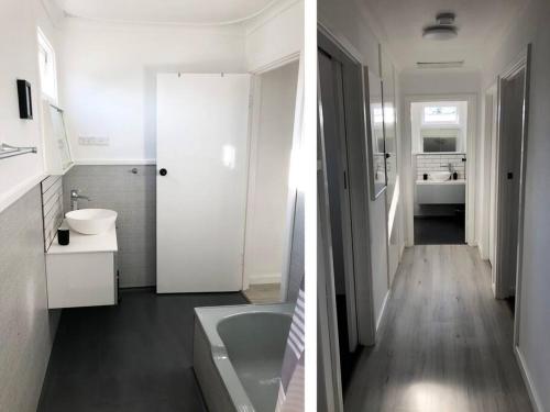 Baño blanco con bañera y lavamanos en Few Steps Into Town - Corner House en Geraldton