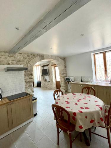a kitchen with a table with a table cloth on it at le petit chalus grand gite in Forcalquier