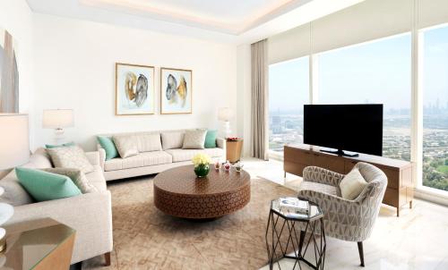 a living room with a couch and a tv at Sofitel Dubai The Obelisk in Dubai