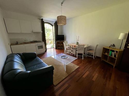 a living room with a black couch and a table at Appartamento in Villa Storica in Oleggio Castello