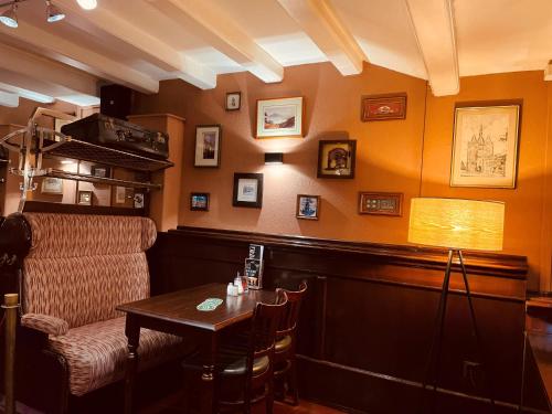 a bar with a table and a chair and a lamp at Hotel Old Quarter in Amsterdam