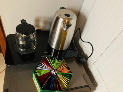 a kitchen counter with a blender and a colorful umbrella at Ishuro Villas in Rukungiri