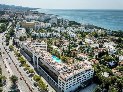 an aerial view of a city and the ocean at Guadalpin Suites in Marbella
