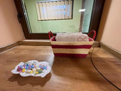 a basket of candy on the floor in a room at Cozy central apartment in Cluj Napoca in Cluj-Napoca