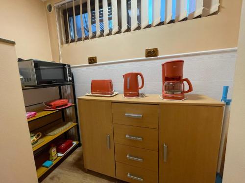 a kitchen with two coffee makers on top of cabinets at Cozy central apartment in Cluj Napoca in Cluj-Napoca