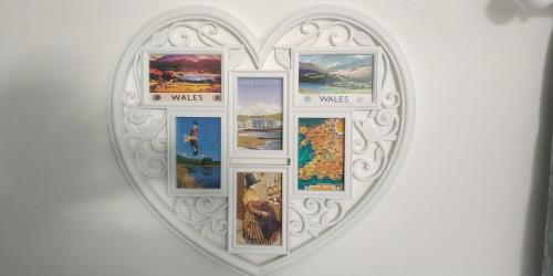 a white heart shaped frame with pictures in it at The Stables in Tregaron