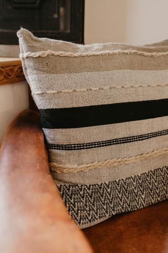 a pillow sitting on top of a couch at Riad Alnadine in Marrakech