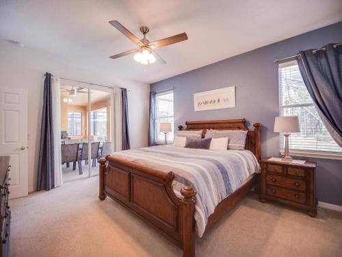 a bedroom with a bed and a ceiling fan at Casa Amore at Ellis Exclusive Villas in Davenport