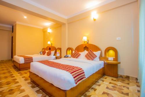een hotelkamer met 2 bedden in een kamer bij Hotel Liberty Pokhara in Pokhara
