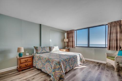 sypialnia z łóżkiem i dużym oknem w obiekcie Carolina Dunes - 503 w mieście Myrtle Beach