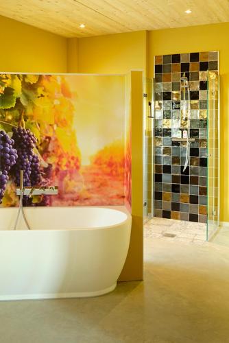 a bathroom with a tub and a painting on the wall at Achterhoeks Goed in Lichtenvoorde-Vragender in Vragender