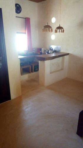 a kitchen with a counter and a sink in a room at LE KABOSS in Toliara
