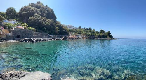 a large body of water with a rocky shore at Nelinda Waterfront Accommodation in Ischia