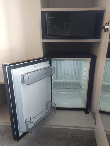 a small refrigerator with its door open and a microwave at The Inn on the Moor Hotel in Goathland