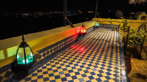 a street with lights on the side of a wall at Riad Green House in Fès