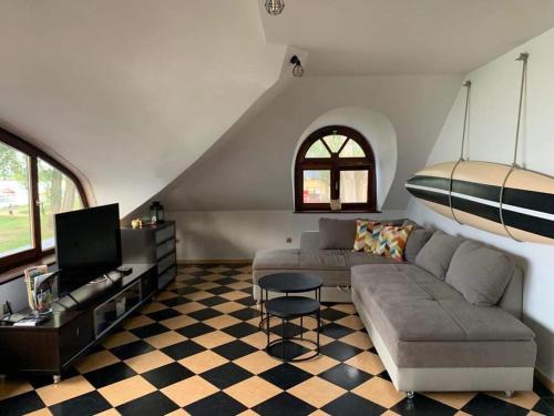 salon z kanapą i telewizorem w obiekcie Szines Panoráma Apartman w mieście Balatonlelle