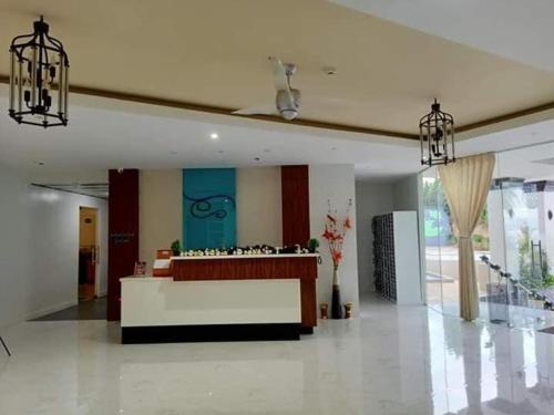 a lobby with a reception desk in a building at Antara Residential Condominium in Talisay
