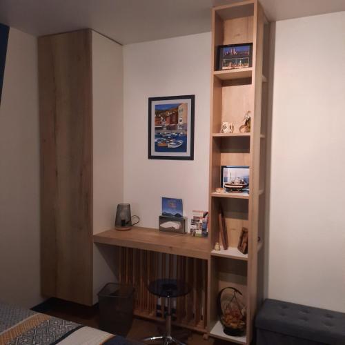 Zimmer mit Bücherregal und Schreibtisch in der Unterkunft REVES BLEUS in Crans
