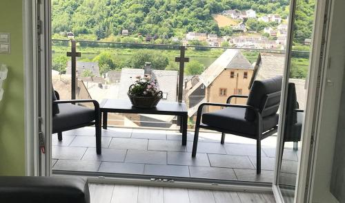 a balcony with a table and chairs and a view at Appartements Im Sonnenberg in Enkirch