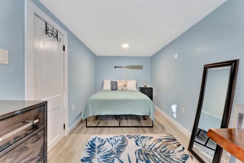 a bedroom with a bed and a mirror at The Tiki Torch Inn Tropical Island Retreat, across from the beach in St Pete Beach