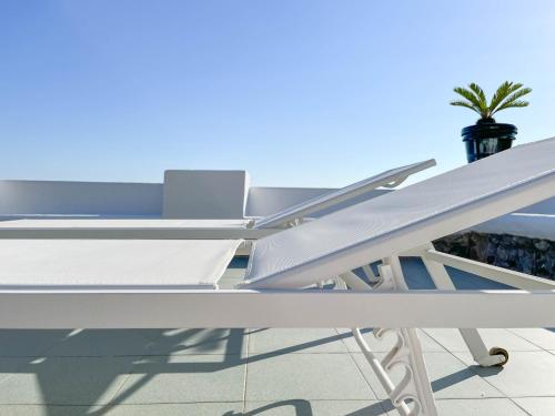 a white table and chairs on a roof at Nelinda Waterfront Accommodation in Ischia